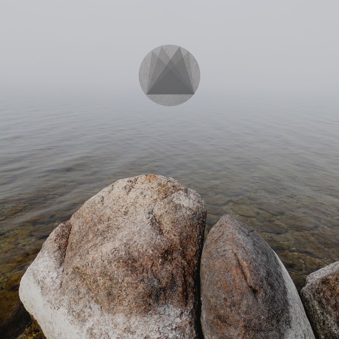 Rocks in the lake in the fog