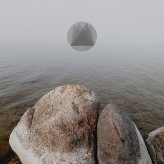 Rocks in the lake in the fog